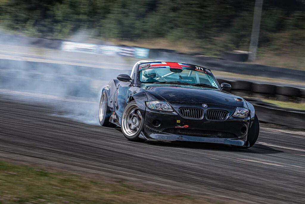 Open top BMW Z4 roadster with a protective roll cage at the local drift track.