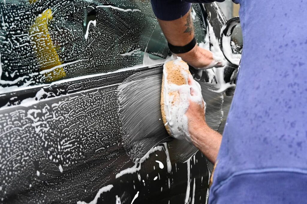 Detailing a convertible car at the hand wash