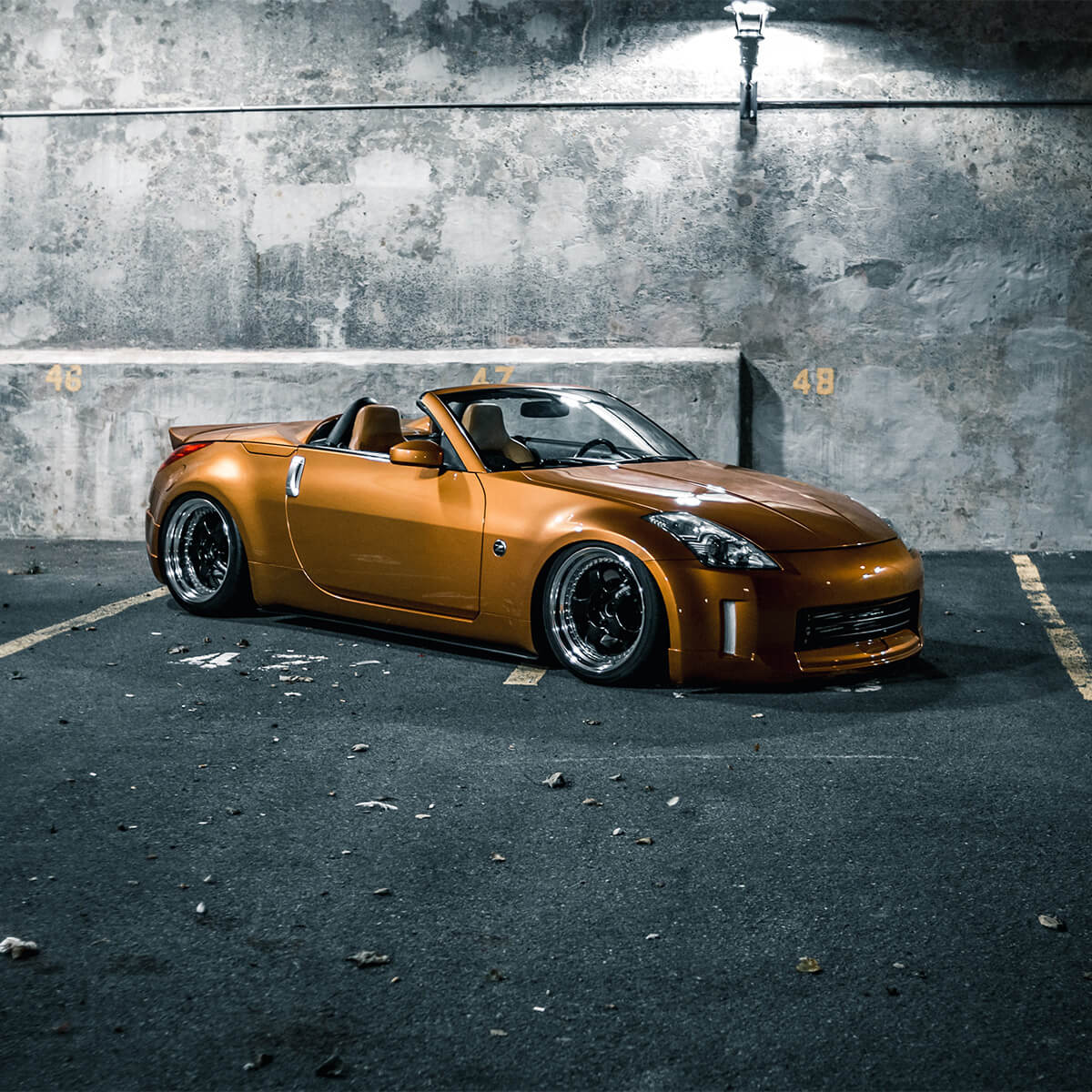 Nissan 350z convertible with a lowered suspension and custom wheels