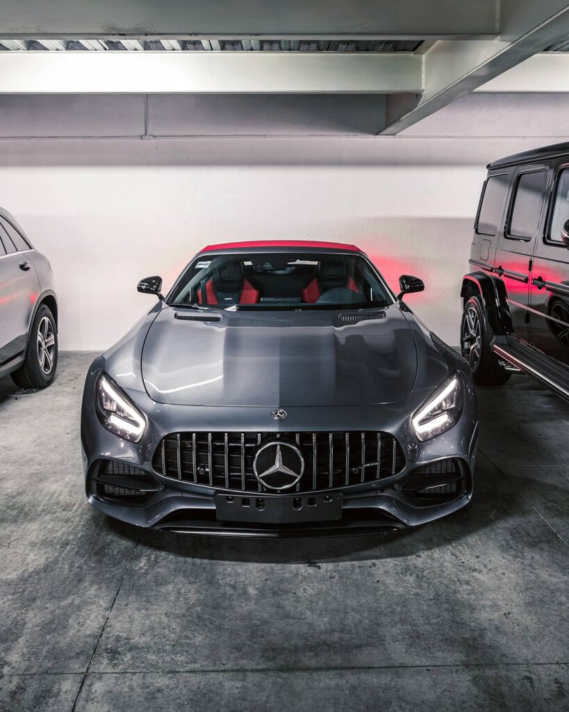 Mercedes AMG GT Roadster with red soft top stored in a parking garage